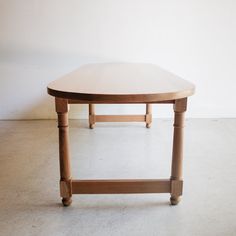 a wooden table sitting on top of a white floor