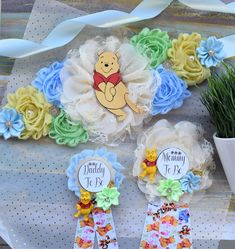 "Winnie the Pooh Baby Shower, Maternity Sash, Mommy To Be Ribbon, Daddy To Be Pin, Boy Baby Shower ❤ This Winnie the Pooh Sash & Pin Set were made especially for a Baby Shower or a Photo Prop. Details: * Maternity Sash: This has nine flowers in Light Green, Light Yellow, Cream, & Light Blue colors embellished with rhinestones and pearls. Additionally, this sash is decorated with lions animals. The ribbon sash is 80'' (2 meters) long. *Mommy to Be Pin: This pin measures approx. 11\" from top of t Winnie Poo, Distintivos Baby Shower, Mommy To Be Pins, Pooh Winnie, Baby Shower Sash, Baby Shower Duck, Winnie The Pooh Baby Shower, Boy Baby Shower Ideas, Disney Baby Shower