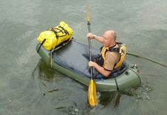 a man is paddling his kayak in the water with a backpack on it