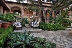 an outdoor living area with chairs and trees