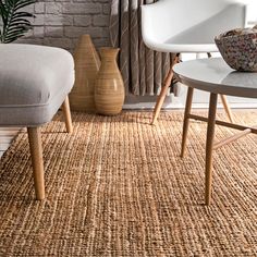 a living room with two chairs and a rug on the floor