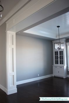 an empty living room with hard wood flooring and white painted trim on the walls