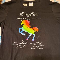 Black Tshirt With Colorful Unicorn Design, Name Taylor And Says "Magic Is In You". Size Medium. Multicolor Cotton T-shirt With Unicorn Print, Multicolor Unicorn Print Crew Neck T-shirt, Black Crew Neck T-shirt With Rainbow Print, Fun Cotton T-shirt With Unicorn Print, Cotton Graphic Tee With Unicorn Print, Colorful Unicorn, Sublimation Shirt, Company Shirts, Design Name