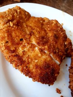 two pieces of fried chicken on a white plate