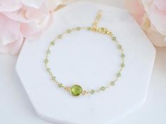 This peridot bracelet is the perfect gift for yourself or a loved one.Peridot is believed to bring good health, restful sleep, and peace to relationshipsPeridot is the birthstone for the month of August and makes a lovely birthday gift.-------------------------------ALL PERIDOT JEWELRYhttps://etsy.me/2YADXpQ-------------MATERIALThe Peridot stone is made via hydrothermal process and the tiny peridot stones are made with gold plated or sterling silver wire.Initial charm is made in stainless steel Green Round Chain Bracelet Gift, Green Jubilee Bracelet Perfect As A Gift, Green Jubilee Bracelet As A Gift, Green Round Birthstone Bracelet, Green Chain Bracelet For May Birthstone Gift, Green Gemstone Crystal Bracelet Gift, Adjustable Peridot Bracelet, Adjustable Peridot Bracelets For Gifts, Faceted Green Beaded Bracelets As Gift