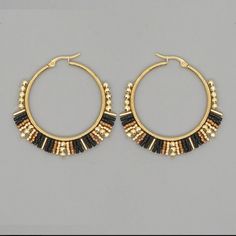 Miyuki Rice Beads Handwoven Hoop Earrings Black & Gold Beads Gold Tone Hoops The Beads On These Earrings Are Woven Very Securely! I Also Have These In Red & Orange And Blue & White. Boho / Bohemian Vintage Style Retro Style Ethnic Style Gypsy Hippie Festival, Coachella, Music Festival, Burning Man, Stagecoach. Bundle & Save. New To Poshmark? Use My Code Bethmgold When Joining For $10 Off Your First Purchase. @Bethmgold I Relist Items Every 1-2 Months (If They Don't Sell Or Are A Multiple Boutiqu Seed Bead Hoop Earrings, Bohemian Vintage Style, Coachella Music Festival, Coachella Music, Turquoise Hoop Earrings, Earrings Classic, Rice Bead, Miyuki Beads, Colorful Earrings