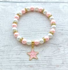 Cute starfish beaded stretch bracelet. Perfect gift for any animal lover for a birthday or a special gift. These are great gifts for little girls aswel as adults, you will find matching items in my store. *The bracelets are available for adults and children. Adults measure approximately 7.5inches unless a note is made. Children sizes vary depending on age of child. *The bracelets are made using 8mm glass pearl beads in any colours of your choice. which can be selected from the menu. *In between the beads are gold rhinestone beads to give a little sparkle.  *In the centre is a gold plated enamel starfish charm. *The charm measures approximately 2cms. ☆☆The bracelet comes presented in a little gift bag, I also have gift wrap and messages available to purchase from my store☆☆ If you have any Playful Star Charm Jewelry For Gifts, Playful Jewelry With Star Charm For Gift, Gold Beaded Bracelets With Starfish Charm As Gift, Starfish Charm Bracelet As A Gift, Adjustable Starfish Charm Bracelet Gift, Starfish Charm Bracelet As Gift, Starfish Charm Bracelet Gift, Star-shaped Bracelet With Starfish Charm Gift, Ocean-inspired Starfish Bracelets As Gifts