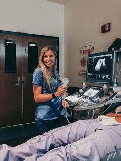 a woman in scrubs standing next to a hospital bed with an x - ray