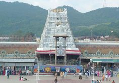 people are walking around in front of a temple