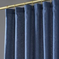 blue curtains hanging on a metal rod