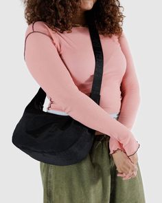 Practical doesn’t have to be boring. Our Medium Nylon Crescent Bag is effortlessly casual and large enough to carry more than just the essentials. Wear it slung over your shoulder or crossbody for a hands-free experience. Complete with two interior pockets that make it easy to stay organized. Adjustable tonal logo strap Measures 8" × 13 ¾" × 4" 47" adjustable logo strap, previously 37 ½" Recycled heavyweight nylon, recycled ripstop nylon lining Machine washable Baggu Crescent Bag, Baggu Crescent, Travel Favorites, Designer Things, Solid Conditioner Bar, Crescent Bag, Wishlist 2024, Stay Organized, Medium Bags