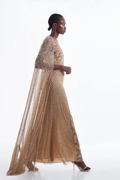 Regal modernity defines this maxi dress, offsetting a scintillating length with the cascading depth of a tulle cape that pools at the floor with celestial aplomb. The intricate embellishments that adorn this after-dark piece call for precious diamonds, metallic stilettos, and a pouch clutch.Plunge neckTulle capeEmbellished finishFishtail skirtMaxi length Fringe Cape, Outfit Ideas For Church, Wedding Outfits For Women, Tulle Cape, Latest Maxi Dresses, Dress With Cape, Maxi Dress Collection, Embellished Maxi Dress, Fishtail Skirt