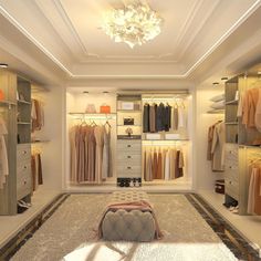 a walk in closet filled with lots of clothes and shoes on shelves next to a chandelier