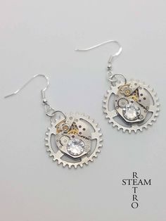 "Elegant Steampunkery! Vintage 17 jewel Watch mechanisms on a fixed gearwheel, featuring 2 stunning clear Swarovski Crystals. The findings are 925 Sterling silver. Lightweight, perfect for adding a touch of class to that steampunk, cosplay outfit, but understated enough to be used for everyday use! the choice is yours! Steamretro has a 100% feedback rating! When you buy from Steamretro you will receive a fantastic Handmade piece of jewelry, quite distinct from any other boutique! We offer FREE s Watch Mechanism, Earrings Gothic, Steampunk Watch, Steampunk Earrings, Steampunk Cosplay, Steampunk Jewelry, Cosplay Outfits, Swarovski Crystal, Swarovski Crystals