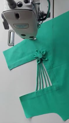 the sewing machine is next to some green cloth