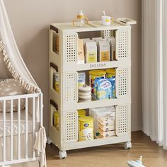 a baby's nursery room with a crib and shelves for diapers, wipes, and other items