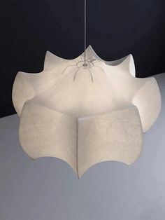 a large white light fixture hanging from a ceiling