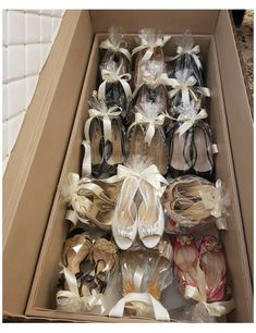 a box filled with lots of different types of shoes and bows on top of each other