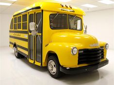 a yellow school bus parked in a white room