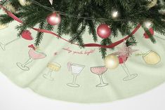 a christmas tree skirt with wine glasses on it