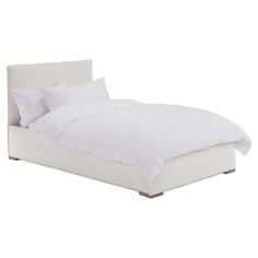 a bed with white sheets and pillows on it