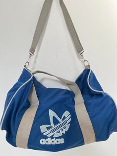 You'll definitely feel cool sporting this 80s gym duffle bag in a nice icy blue and grey colour combo.  17"L x 10"W x 9"H Great condition for the age. Adidas Logo Nylon Bags For Outdoor Activities, Adidas Nylon Travel Bag, Functional Adidas Everyday Bag, Functional Everyday Adidas Logo Bag, Sporty Adidas Logo Bag, Casual Adidas Logo Bags For Everyday Use, Functional Adidas Logo Bag, Casual Adidas Logo Bags For Outdoor Activities, Casual Adidas Sports Bags