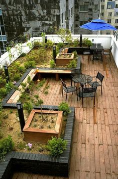 an outdoor seating area with tables, chairs and umbrellas on the roof top deck