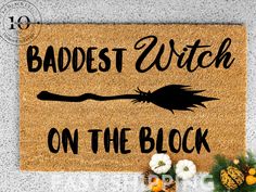 a door mat that says, baddest witch on the block