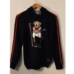 This Hooded Sweater Features Our Iconic Polo Bear Dressed For A Day On The Slopes. Shell: 100% Cotton. Design: 81% Wool, 19% Cotton. Machine Washable. Size Medium Has A 21.5" Body Length (Front And Back) And A 20.5" Sleeve Length. Hood. Long Sleeves With Rib-Knit Cuffs. Polo Bear Intarsia-Knit At The Center Front. "Rl" Cross-Stitched At The Left Hem. Rib-Knit Hem. Imported. Style Number: 629069 Color: Black Size: Boys Large 14-16 (160cm) Condition: New With Tag, New In Plastic Ships From Smoke F Ralph Lauren Sporty Winter Hoodie, Sporty Ralph Lauren Winter Hoodie, Ralph Lauren Cotton Sweatshirt For Winter, Ralph Lauren Sporty Hoodie For Fall, Ralph Lauren Winter Hoodie With Drawstring Hood, Ralph Lauren Long Sleeve Sweatshirt For Winter, Sporty Ralph Lauren Hoodie For Fall, Ralph Lauren Fall Hoodie Sweatshirt, Ralph Lauren Long Sleeve Winter Hoodie