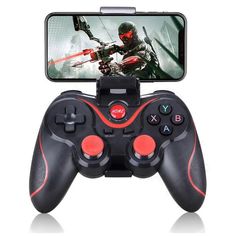 an image of a game controller with a phone in the back ground and on top of it