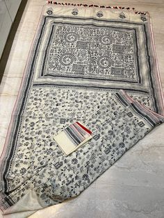 A beautiful Worli work kantha saree . The whole body of the saree finished with intricate hand stitch kantha works . To give a unique look to that black and white red piping added .  Saree comes with a running blouse piece with kantha work on sleeves . Fall pico and tassels done . You can wear it with a red blouse also.  Blouse stitching option is here . Unstitched Bohemian Tussar Silk Saree, Unstitched Bohemian Chanderi Saree, Unstitched Chanderi Bohemian Saree, Bohemian Semi-stitched Saree With Motifs, Raw Silk Saree With Printed Border, Bohemian Tussar Silk Blouse With Traditional Patterns, Bohemian Block Print Saree For Puja, Bohemian Tussar Silk Embroidered Saree, Semi-stitched Raw Silk Saree With Printed Border