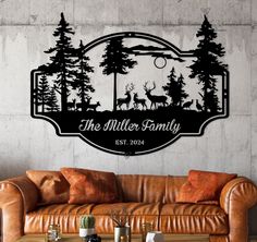 a living room with a couch, table and wall decal that says the miller family