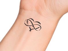 a small wrist tattoo with the letter s on it