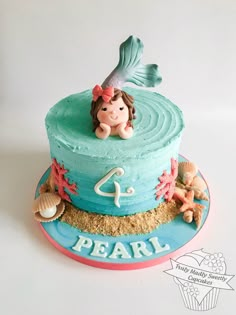 a birthday cake with a little mermaid on top