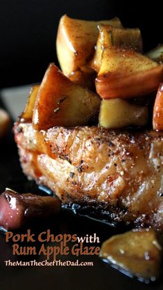 pork chops with rum apple glaze and potatoes on a black plate, ready to be eaten