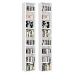 two white bookcases filled with books and dvds