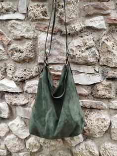 Features : - green suede, - hand dyed leather, - Unlined, - Metal finishes are brass colored, - Closed with zip, - Inside cotton zipped pocket, Size :  - Heigth 16 inch, - Width 13.4 inch, - Depth 4 inch, - Adjustable shoulder strap. - Amovable handle. Handmade suede hobo bag made with soft green suede. This bag is unlined, inside there is a big cotton zipped pocket. The strap is make with stronger hand dyed leather and is adjustable between 21,65 inch and 43,30 inch. The bag has an amovable han Suede Hobo Bag, Strong Hand, Suede Handbags, Suede Tassel, Hobo Bags, Green Suede, Hobo Handbags, Pocket Size, Green Bag