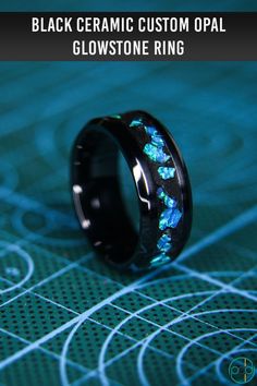 This beautiful black ceramic glow ring feature a green glow and a stunning bright blue opal. #glow #glowring #blackceramic #weddingring #engagementring #glowstone #patrickadiardesigns Black Titanium Round Jewelry, Black Titanium Jewelry Gift, Black Titanium Jewelry As Gift, Black Opal Round Jewelry, Glow Ring, Delicate Gold Ring, Pink Morganite Engagement Ring, White Sapphire Engagement Ring, Mens Rings