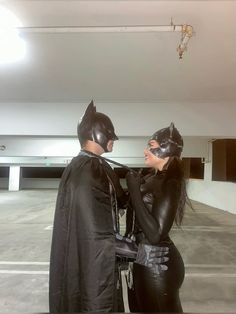 two people dressed up as batman and catwoman