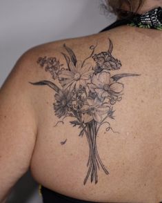 the back of a woman's shoulder with flowers on it