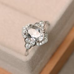 a diamond ring sitting on top of a box