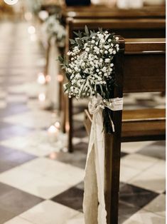 a bouquet of flowers is tied to the pews