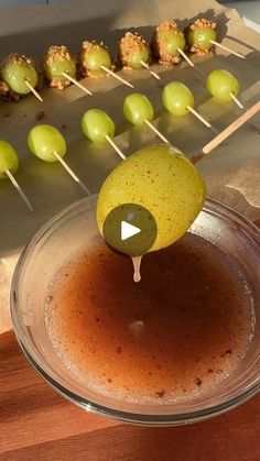 an appetizer is being made with olives on skewers