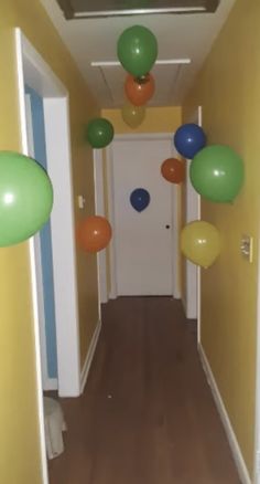 the hallway is decorated with balloons and streamers