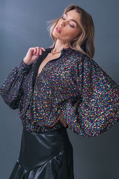 The Freedom Calls Sequin Top combines timeless design with modern style. It features a shirt collar, long sleeves, and an elasticized waistband for a figure-flattering fit. The glimmering sequins add a touch of glamour to any occasion. Details Self : 100% Polyester Lining : 100% Polyester Size & Fit - Model is 5`8" And Wearing Size Small - Measurements Taken From Size Small - Approx. Length: 21" Spring Glamorous Shiny Blouse, Glamorous Shiny Blouse For Spring, Glitter Blouse For Night Out In Fall, Fall Glitter Blouse For Night Out, Glitter Blouse For Night Out, Fall Night Out Glitter Blouse, Stretch Long Sleeve Sequin Blouse, Chic Shiny Blouse For Fall, Chic Long Sleeve Glitter Tops