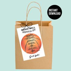 a brown paper bag with an orange basketball on it and the words basketball survival kit