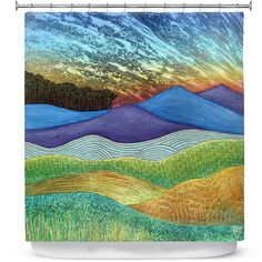 an abstract painting shower curtain featuring mountains and grass at sunset with clouds in the sky