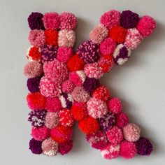 the letter k is made up of pom - poms