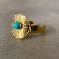 This beautiful Blue Turquoise Ring Gold - "North Star" Ring is the perfect piece to add a touch of spirit-centered style to any outfit. This beautiful jewelry piece is inspired by the north star, which is a powerful symbol of guidance and protection. The luminous turquoise stone represents wisdom and truth, while the adjustable gold-plated stainless steel band ensures a perfect fit.      	Size: Adjustable - 6,7,8,9  	Free Shipping 2 Days  	Authentic Green Stone: Blue Turquoise  	18k Gold Pl Adjustable Gold Turquoise Ring In Spiritual Style, Adjustable Gold Spiritual Turquoise Ring, Gold Adjustable Turquoise Ring, Adjustable Gold Turquoise Ring, Adjustable Symbolic Blue Rings, Symbolic Adjustable Blue Rings, Turquoise Ring Gold, North Star Ring, Vintage Promise Ring