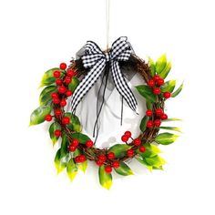 a wreath with red berries and green leaves